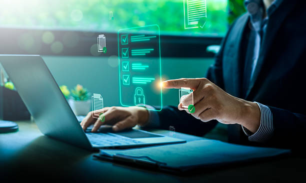 istock Business compliance and digital document security concept with businessman using laptop and holographic checklist interface for data protection, regulation, and secure online management system 2231903599