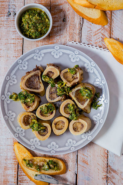 Appetizing Roasted Bone Marrow with Herb Sauce and Toasted Baguette