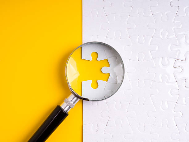 istock Magnifying glass focusing on a missing puzzle piece, representing recruitment, hiring the right candidate, solving problems, solutions, job search, vacancy, human resources, and business strategy. 2231909231