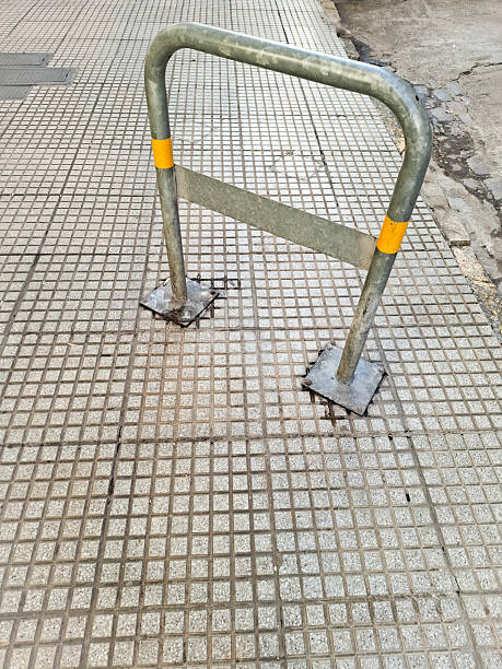 Bicycle rack stands ready for bikes on concrete paving stones