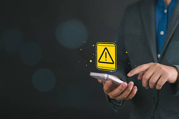 istock System hacked warning alert, Businessman using smartphone with cyberattack network, virus, spyware, scam or Malicious software. Cybersecurity and cybercrime. Compromised information internet. 2231912855
