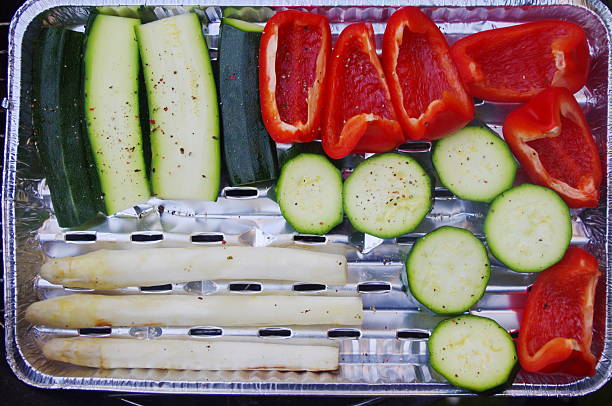 Pan of vegetables including asparagus, peppers, and cucumbers. The vegetables are arranged in a way that they look like a flag