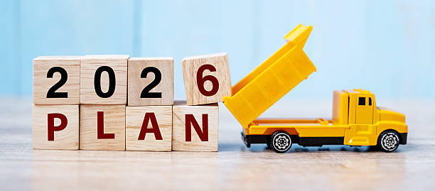 istock 2026 Plan cube blocks with miniature truck or construction vehicle. New Start, Vision, Resolution, goal, industrial, Warehouse and happy New Year concept 2231922474
