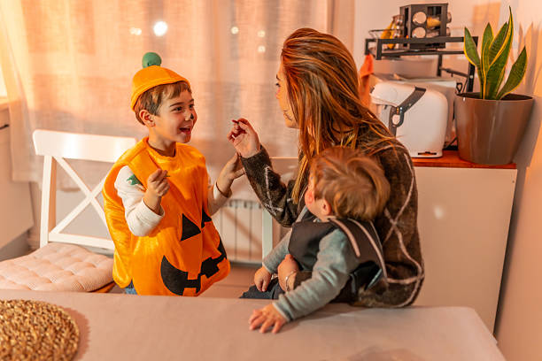 istock Mother applying halloween makeup to her son at home 2231922486
