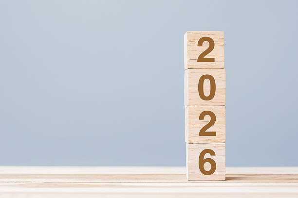 istock wooden cube block with 2026 text on table background. Resolution, plan, review, goal, start and New Year holiday concepts 2231922501