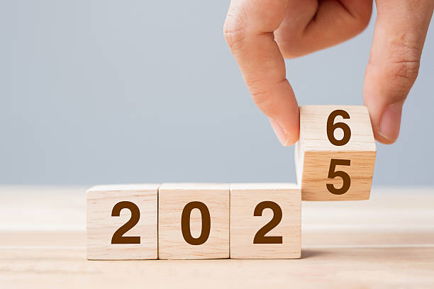 istock hand flip cube block 2025 to 2026 text on table. Resolution, review, strategy, end year, goal, business and New Year holiday concepts 2231922502