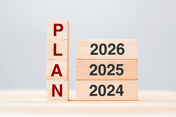istock hand pulling 2026 block over 2025 and 2024 wooden building on table background. Business planning, Risk Management, Resolution, strategy, solution, goal, New Year New You and happy holiday concepts 2231922516