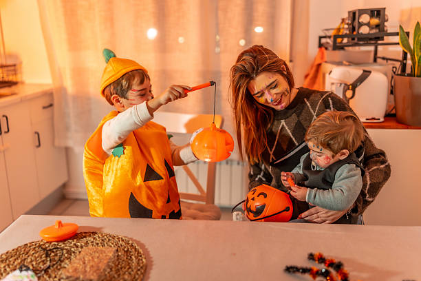 istock Family playing with halloween pumpkin baskets at home 2231922818