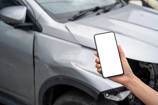 istock Hand Holding Smartphone with Blank Screen in Front of Car Accident 2231923831