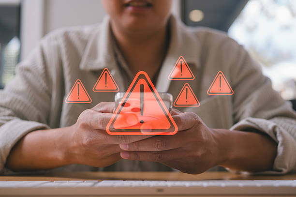 istock businessman using smartphone with virtual triangle caution sign, investment risk management strategy Category Business cyber security 2231926702