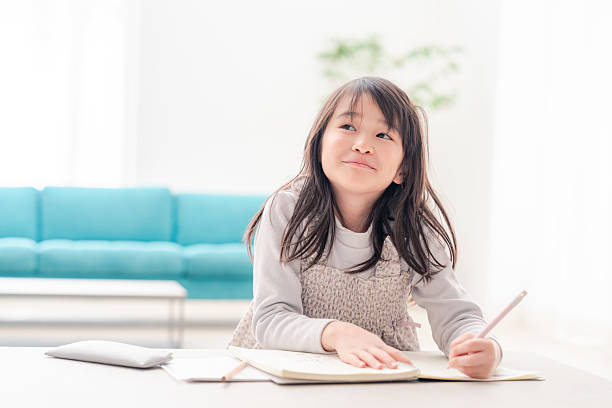 istock Early elementary school girl doing homework alone at home 2231927251