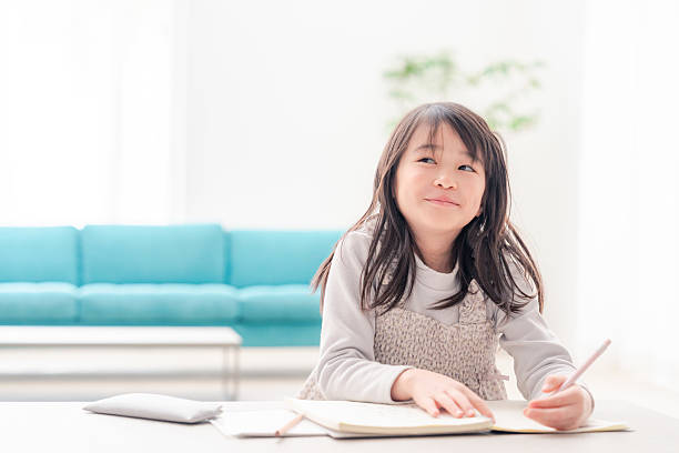 istock Early elementary school girl doing homework alone at home 2231927254