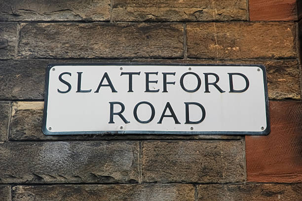 Traditional Edinburgh street name sign for Slateford Road on a sandstone wall