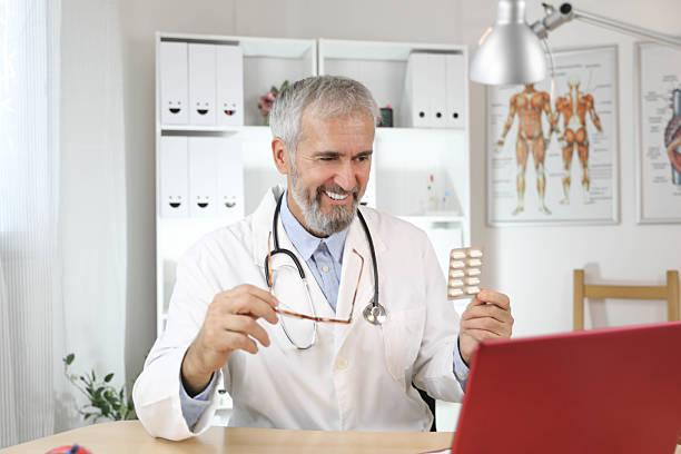 istock Experienced Male Physician Using Laptop for Telehealth Communication 2231941107