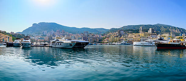 Panoramic view on the Monaco harbour in in La Condamine and Monte Carlo from above during a beautiful summer day. Various yachts and superyachts are moored in the port of the city on the French Côte d'Azur.