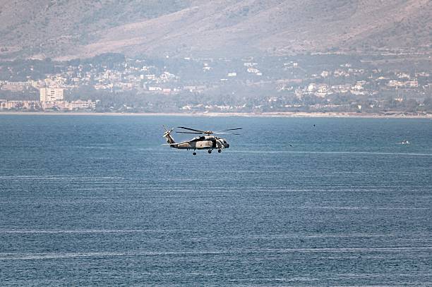 Zamardi, Hungary - September 16, 2020: Hungarian air police MD900 Explorer helicopter flying operation. SAR Search and rescue mission with rope.
