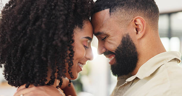 istock Love, connection and couple with forehead touch in home for affection, security or bonding together. Happy, people and trust in marriage with protection, commitment and healthy relationship in house 2231945057