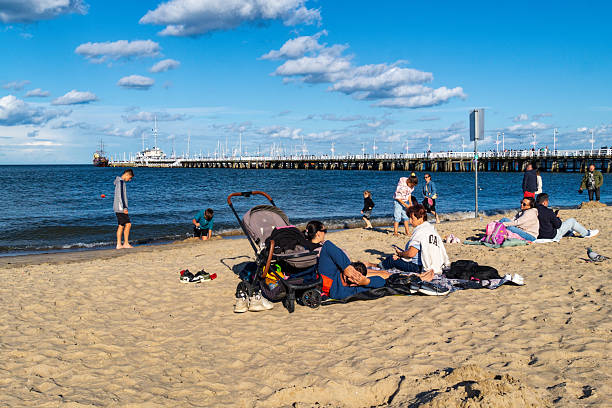 Sopot, Poland - August 24, 2025: Family vacations on the Baltic Sea coast. People resting on the sandy beach in Sopot