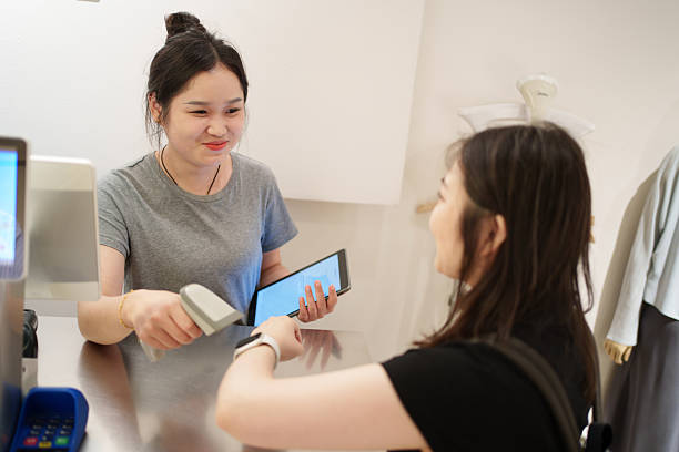istock Asian female customer using smartwatch to pay in store 2231950726