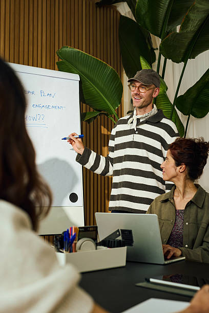 Diverse team discussing five year plan for increasing engagement in modern office