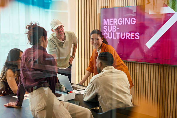 Business team discussing merging sub-cultures in modern office