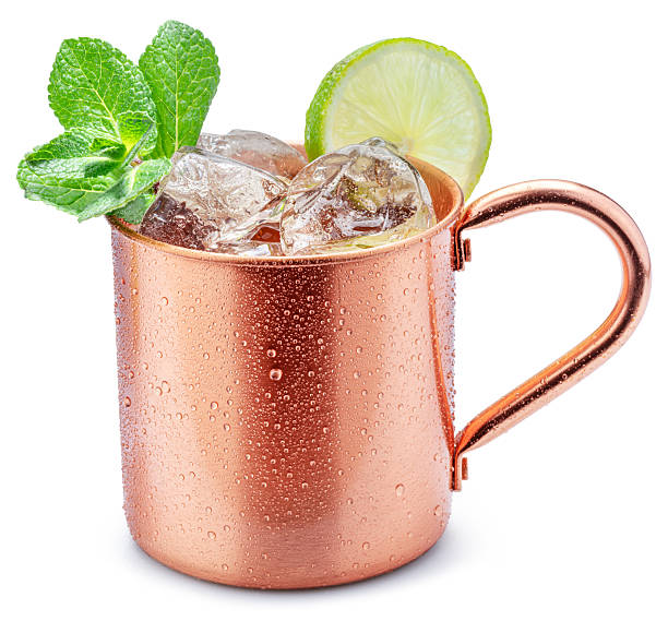 istock opper cup with Moscow mule drink decorated with lime and mint leaves white background. Clipping path. 2231952470