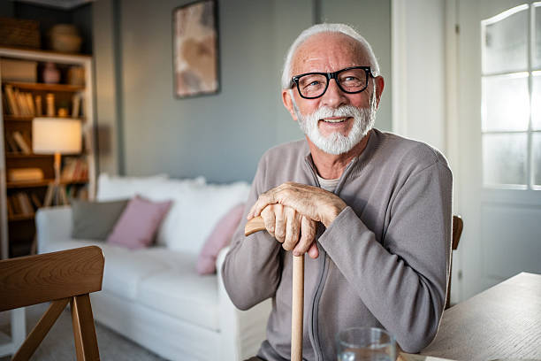 istock Happy senior man smiling at home with walking cane 2231956474