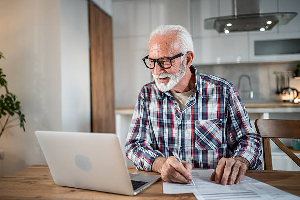 istock Senior man managing finances and working remotely from home 2231957217