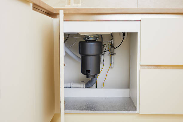 istock The installation of a functional garbage disposal unit beneath the kitchen sink showcases essential plumbing setup. 2231960033