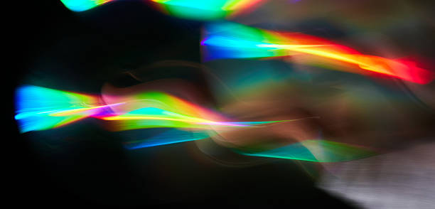istock Blurred bright rainbow light. Lens or prism dynamic flare. Draving shiny spots. Dark background. Illuminated burst of multicolor light. 2231960092