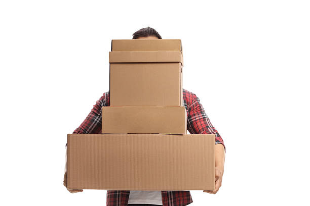 istock Man holding a tall pile of cardboard boxes 2231960368