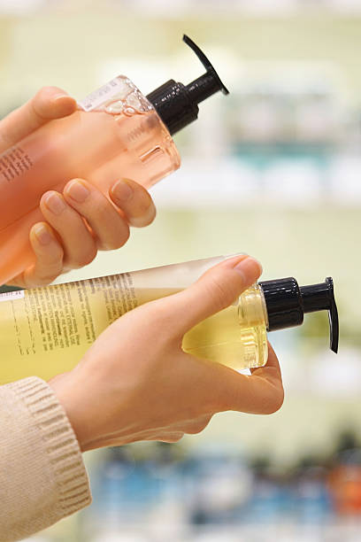 istock Customer comparing personal care products, reading ingredient labels. 2231960416