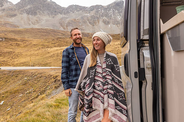 istock Couple Enjoying Mountain View from Camper Van 2231960587