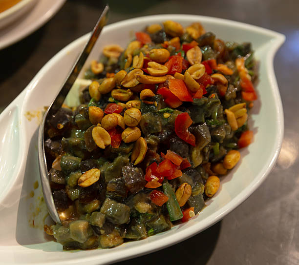 istock Spicy century egg salad red peppers crushed peanuts herbs white dish 2231960618