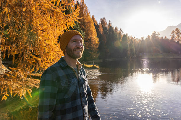 istock Man Enjoying Autumn Lake View at Sunset 2231961501