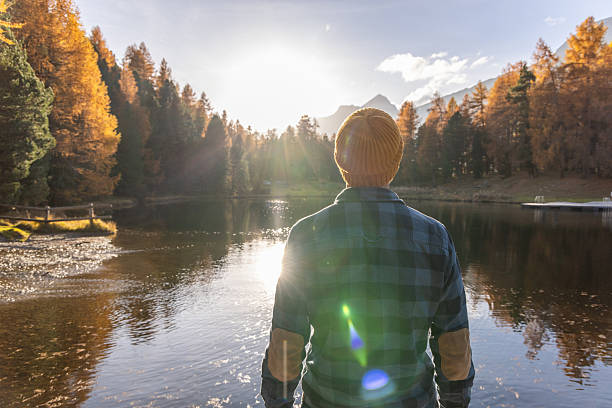 istock Man Enjoying Autumn Lake View at Sunset 2231961623