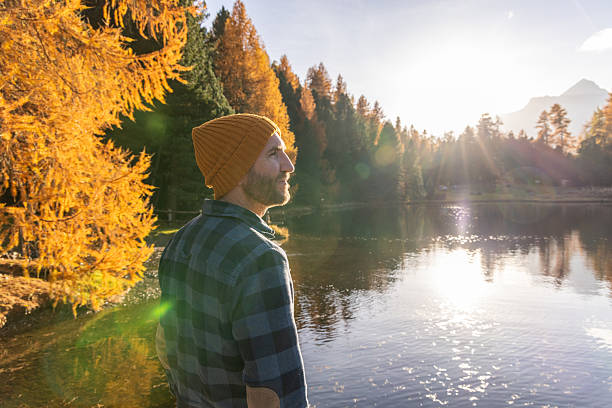 istock Man Enjoying Autumn Lake View at Sunset 2231961625