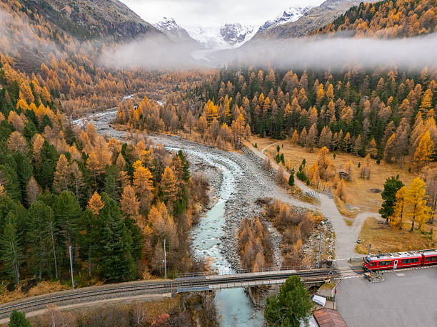 istock Autumn Mountain River Valley with Red Train 2231963792