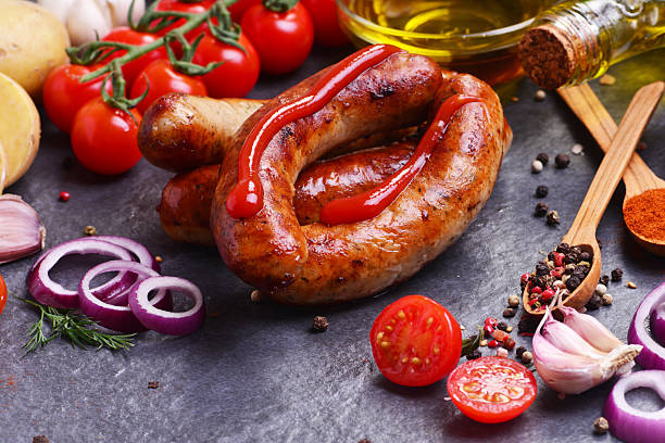 istock Pork sausages with spices and vegetables 2231963937