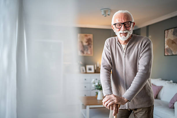 istock Happy senior man smiling at home with walking stick 2231964154