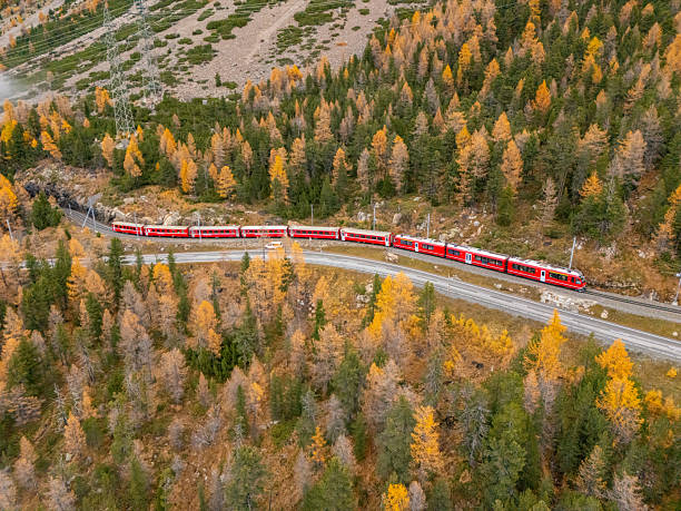 istock Red Train Traveling Through Autumn Mountain Forest 2231964598