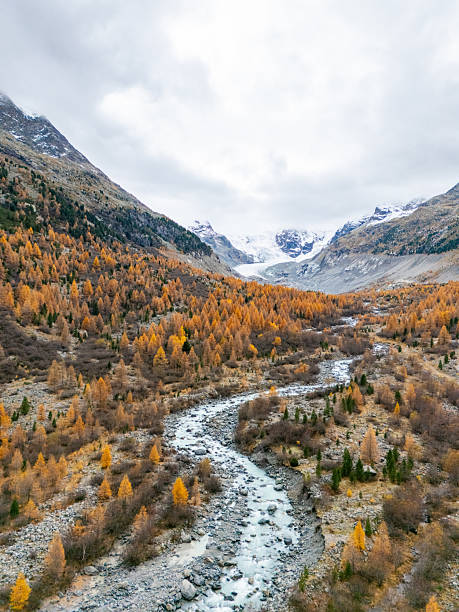 istock Autumn Valley with River and Snowy Mountains 2231964905
