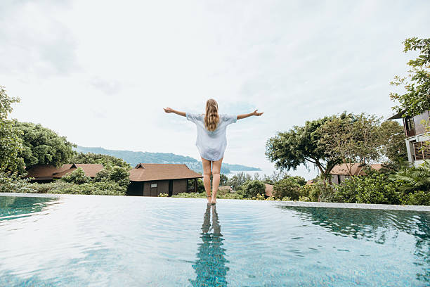 istock Woman Walking Barefoot Along Tropical Pool Edge 2231964986