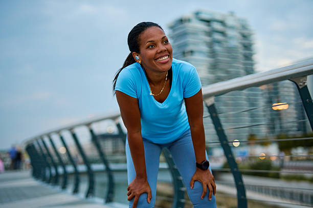 istock Young woman taking a break during her evening workout routine 2231965419