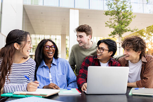istock Cheerful university students collaborating on a project outdoors 2231966713