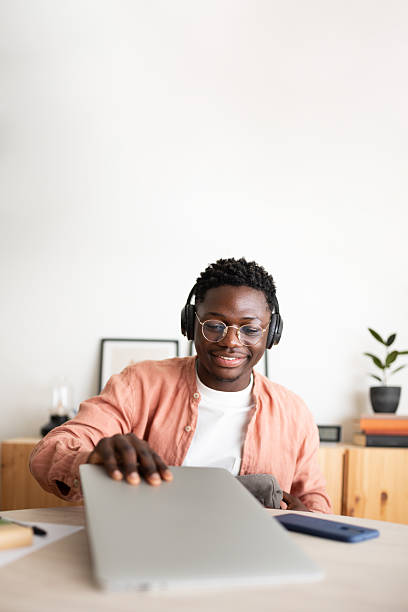 istock Young man closing laptop after finishing work from home 2231966719