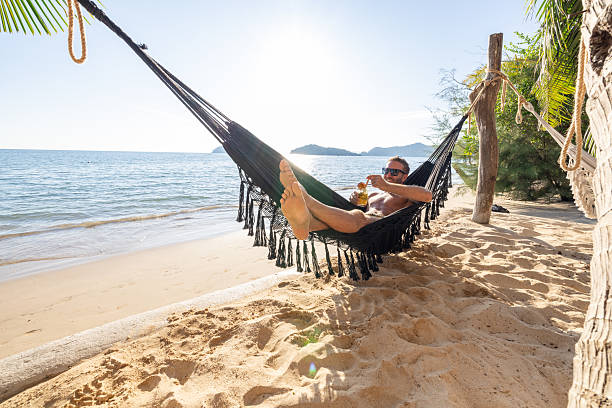 istock Man Relaxing in Hammock on Tropical Beach 2231966740