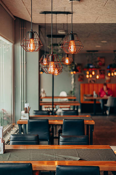 istock Industrial Cage Lamps in Modern Cozy Cafe Interior 2231966842