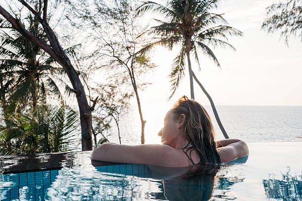 istock Luxury Hotel Vacation: Woman Enjoying Infinity Pool Sunset 2231967343