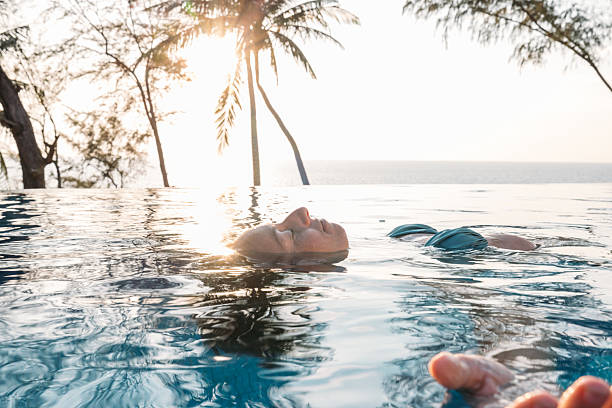 istock Woman Floating in Infinity Pool 2231968142